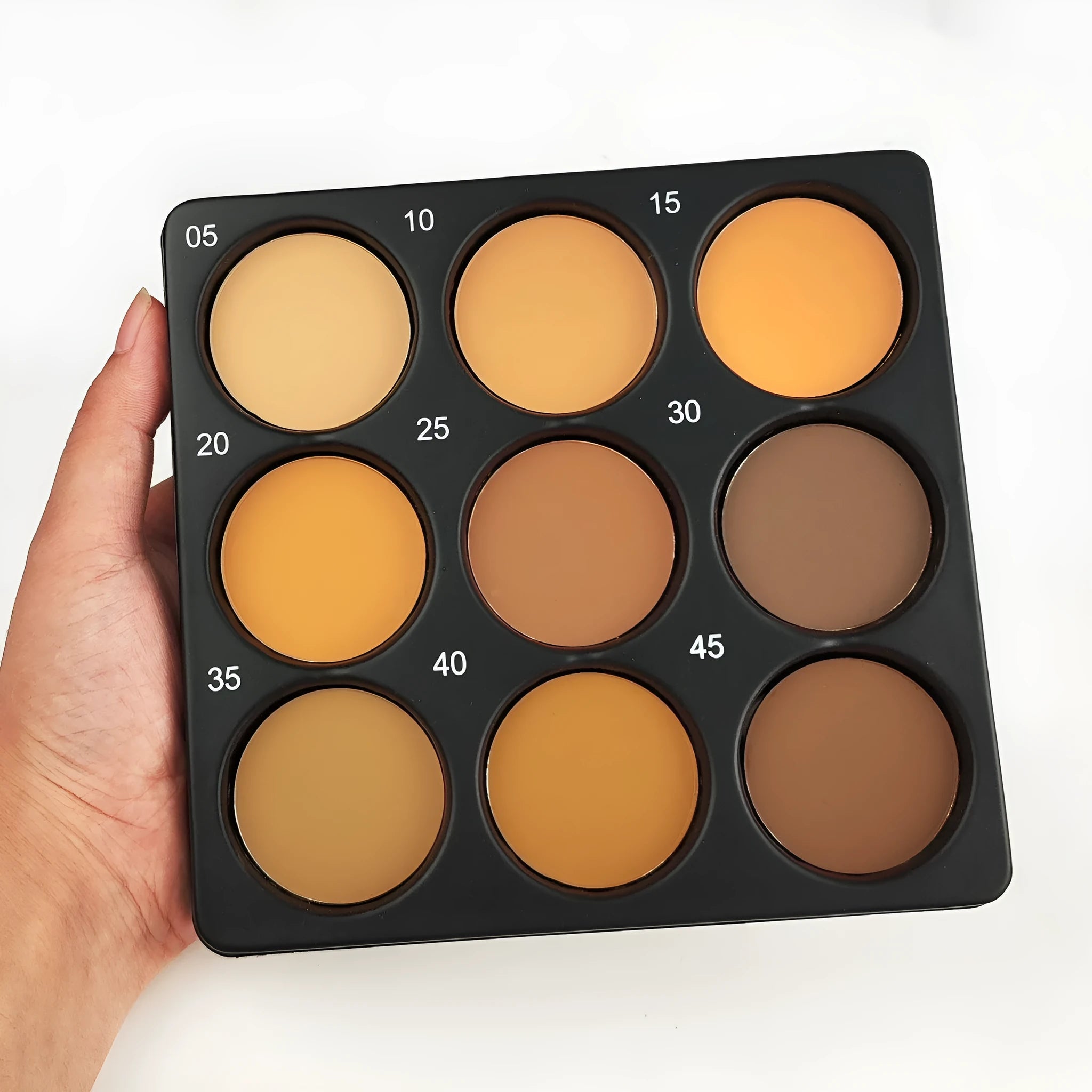 Dark matte makeup palette open showing nine waterproof eyeshadow shades.