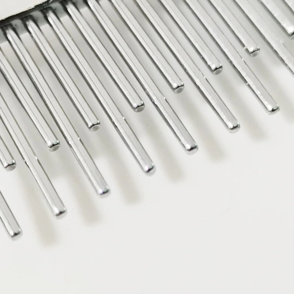Red pet dematting comb with short and long stainless steel teeth and a plastic handle.