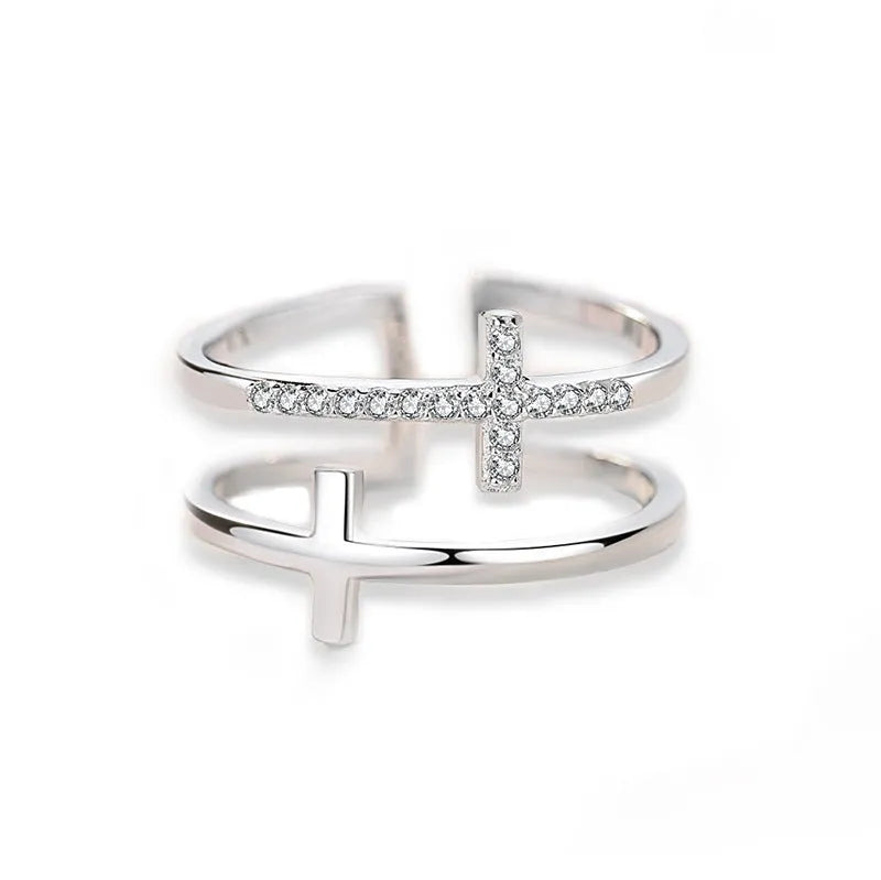 Adjustable double cross geometric ring in white gold colour with sterling silver and zircon gem inlay.