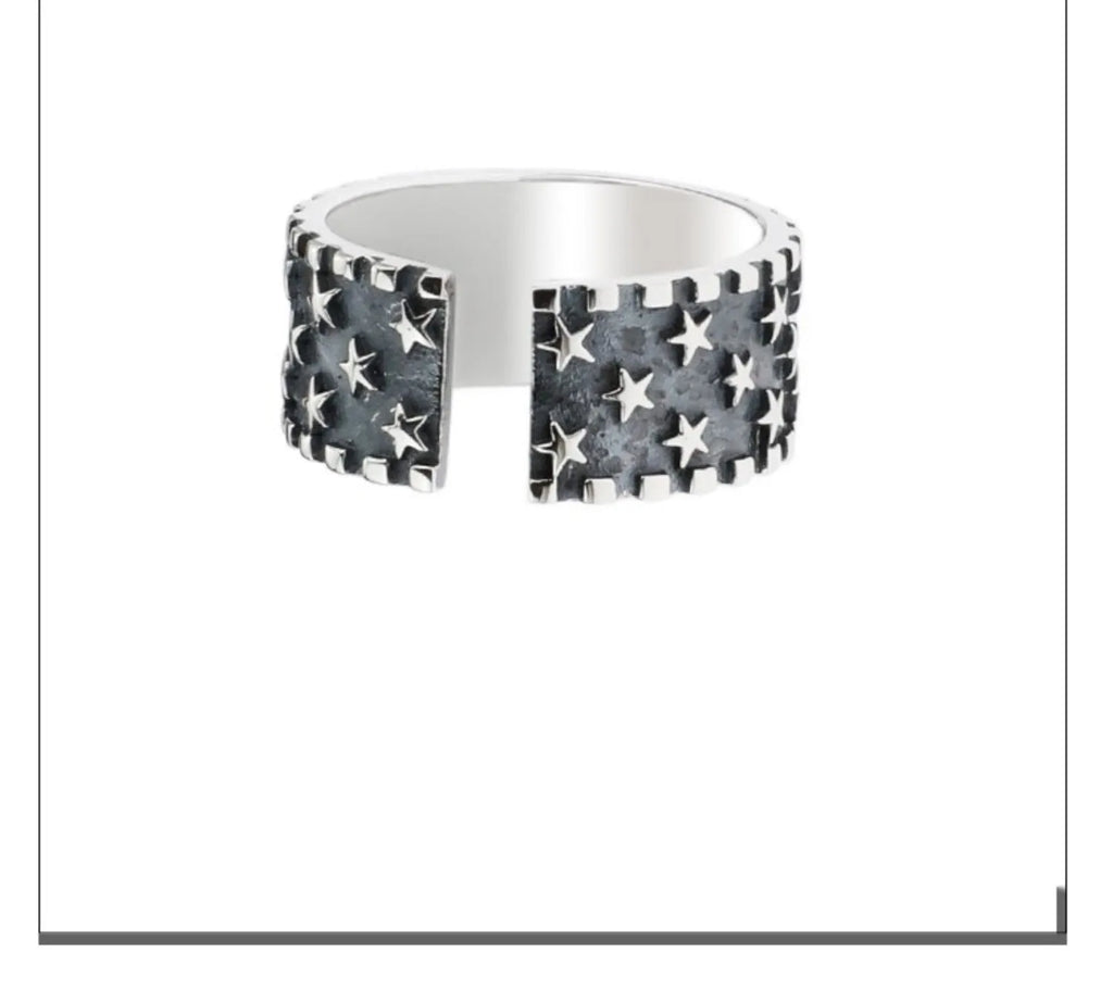 Adjustable silver ring with a geometric pattern of multiple five-pointed stars on a white background.