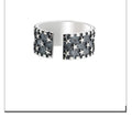 Adjustable silver ring with a geometric pattern of multiple five-pointed stars on a white background.