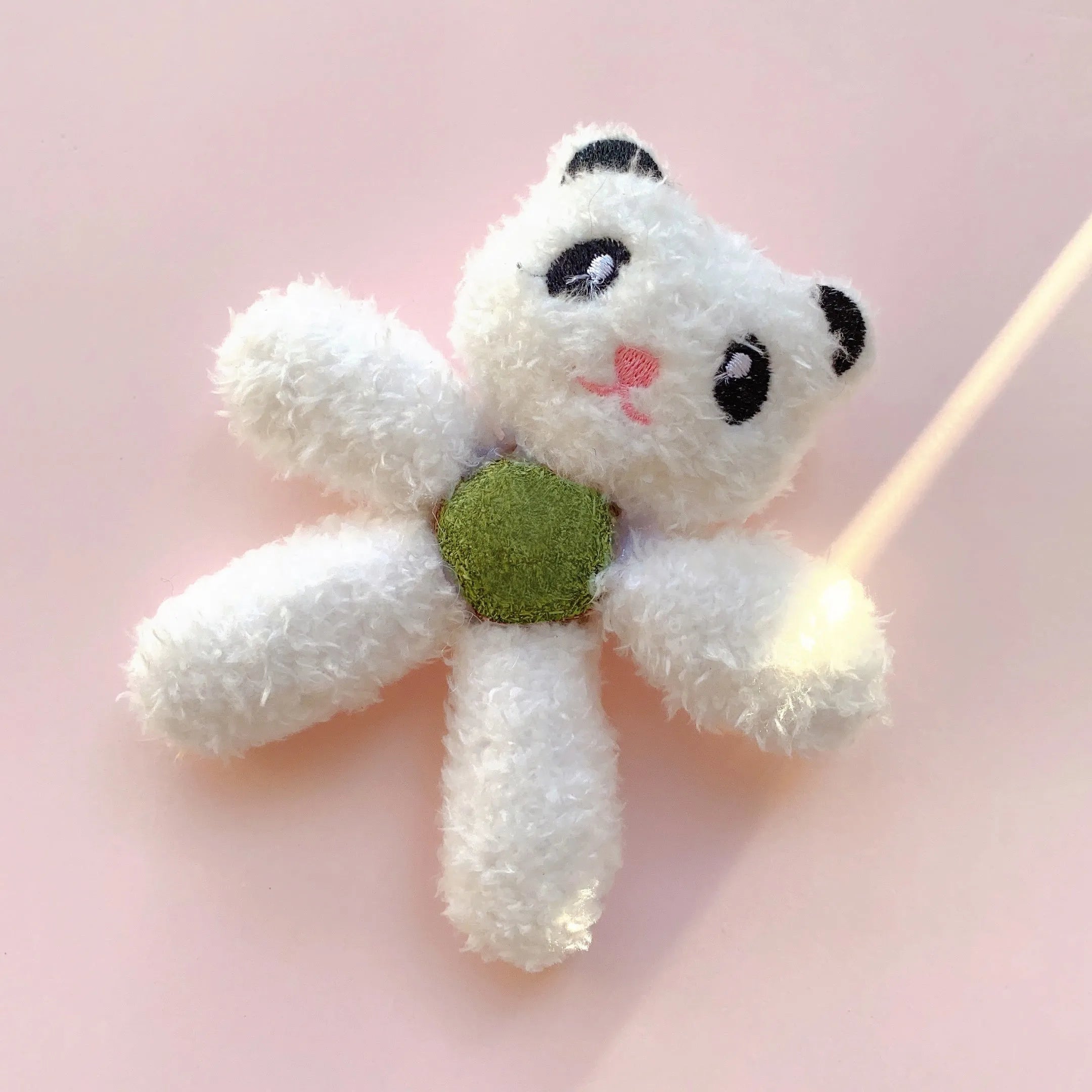 Soft brown bear-shaped catnip chewing ball toy for cats on a white background.