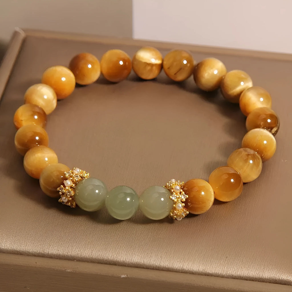 Natural yellow tiger's eye and Hetian jade bead bracelet in a U-shape, showing golden gourd design.