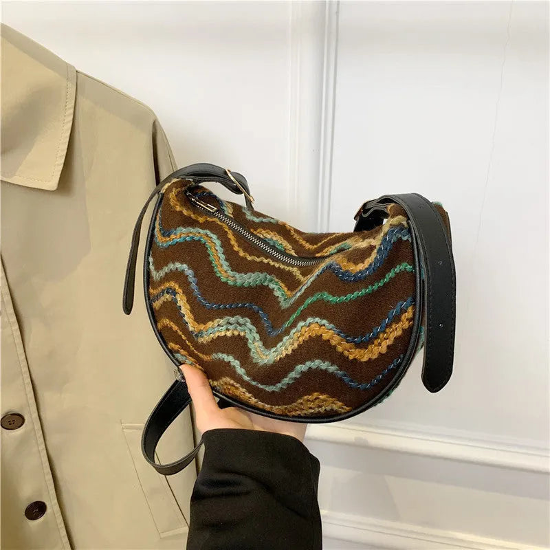 Women's knitted straw woven crossbody bag in corrugated black carrying phone and files