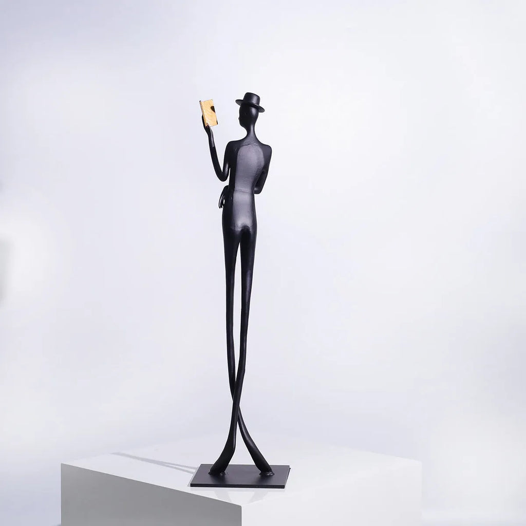 Black cast aluminium desktop sculpture of reading woman figure, modern design