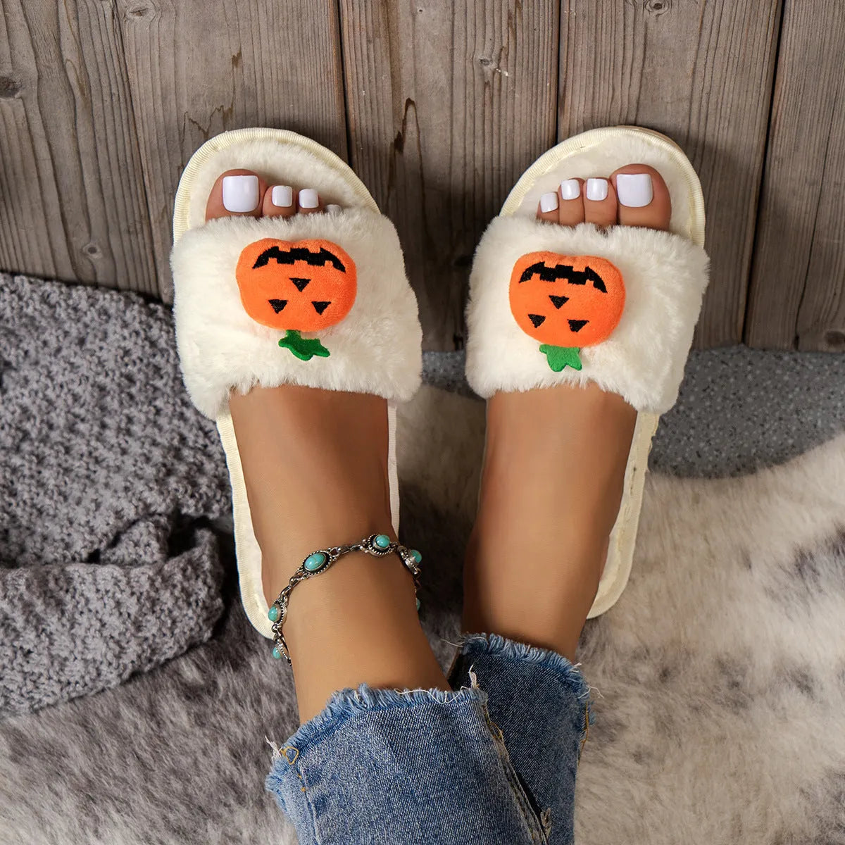 Halloween pumpkin plush slippers in white and yellow with synthetic fur and open toe design