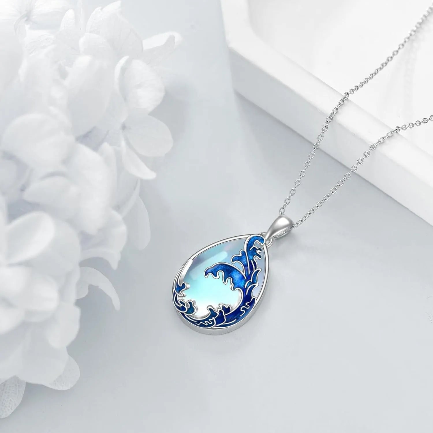Moonstone blue alloy heart pendant necklace with chain on white background