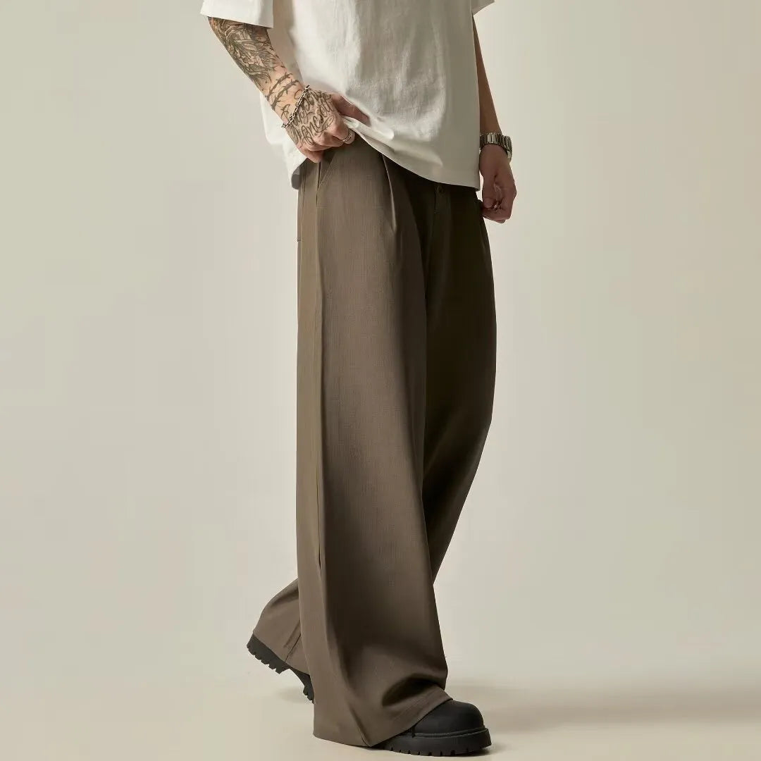 Man wearing black solid colour wide-leg casual trousers with a vertical tube design.