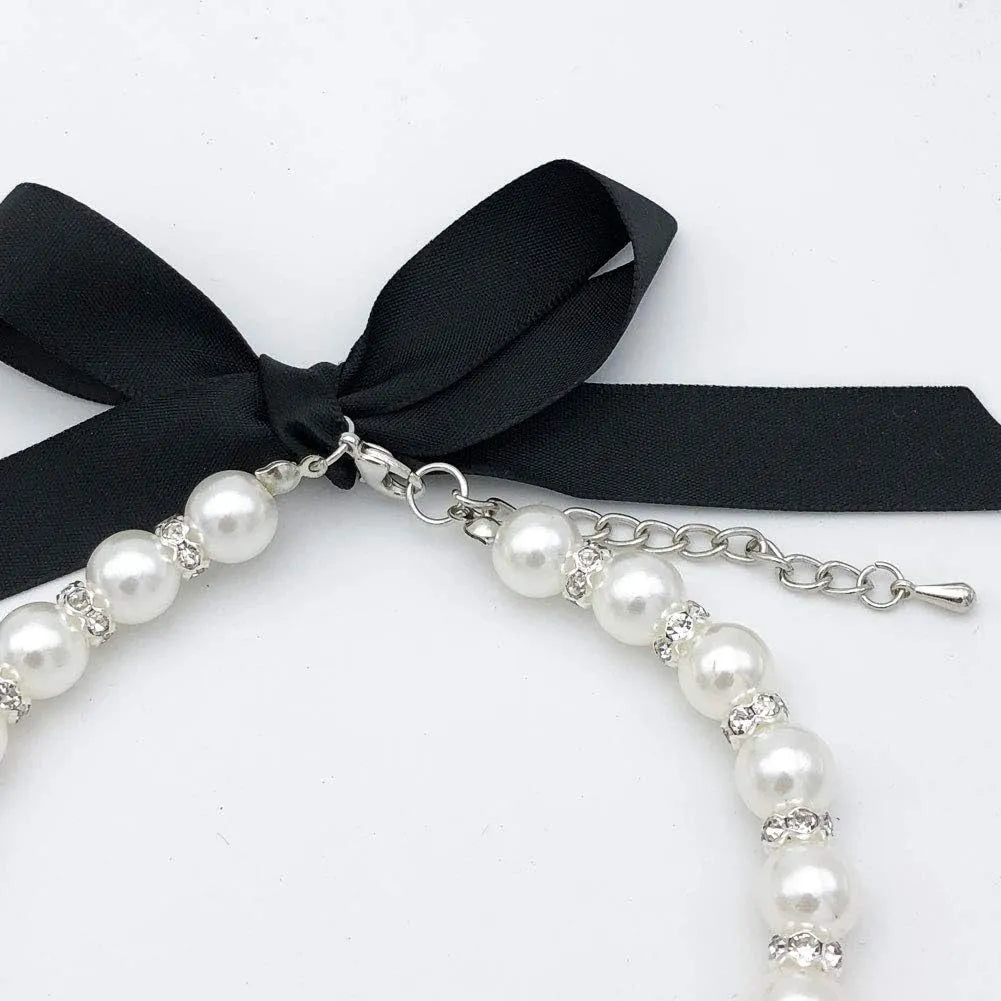 Adjustable dog necklace with imitation pearls, rhinestones, and ribbon bow for small pets