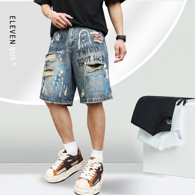 Men's blue ripped jeans shorts with graffiti details and straight leg opening