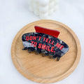 Handcrafted Halloween hair clip with detailed shark and bat design in acetic acid.