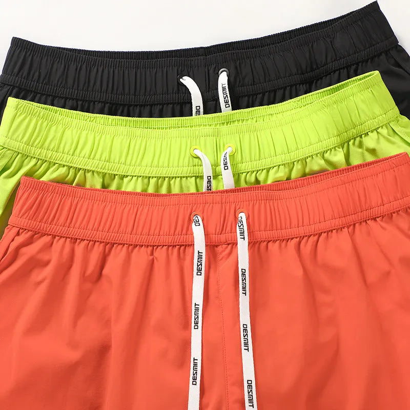 Men's elastic beach shorts in orange, green, and black colours for surfing and summer wear