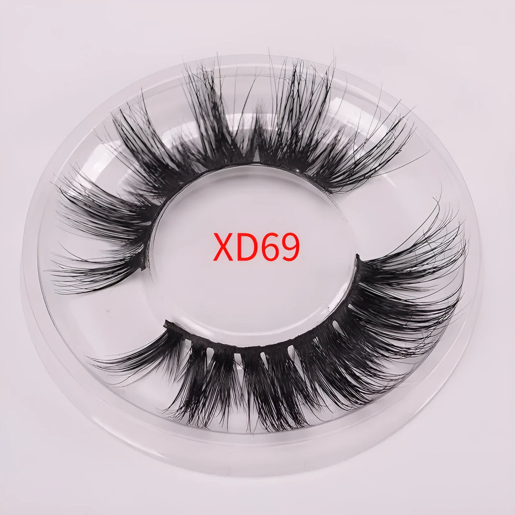 5D Mink False Eyelashes set with hair cap and double-headed brush on a pink background.