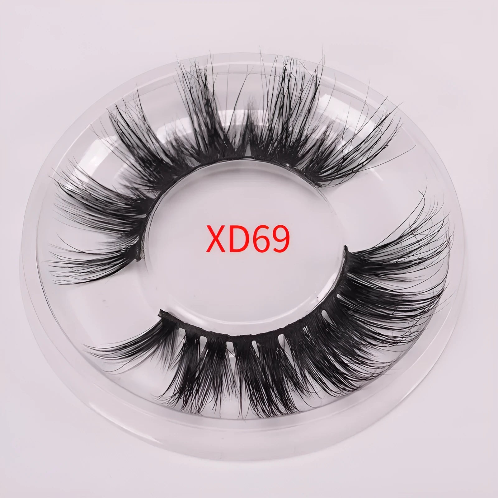 5D Mink False Eyelashes set with hair cap and double-headed brush on a pink background.