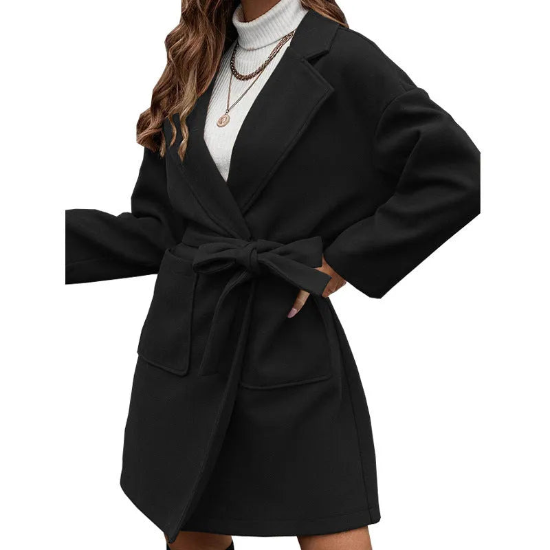 Minimalist long sleeve lapel button coat in a light blue colour, featuring a split belt and a loose casual fit.