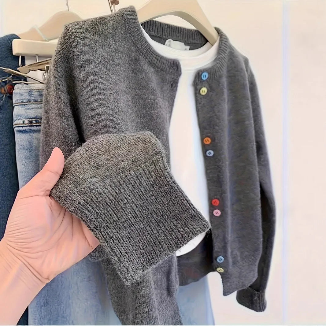 Dark grey women's button-front polyester cardigan on a hanger.