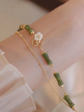Natural green olivine bracelet with double layer design featuring olive branches and bells of Ireland motifs