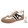 Women's retro colour matching lace-up jogging shoes in black with cross strap and low platform heel.