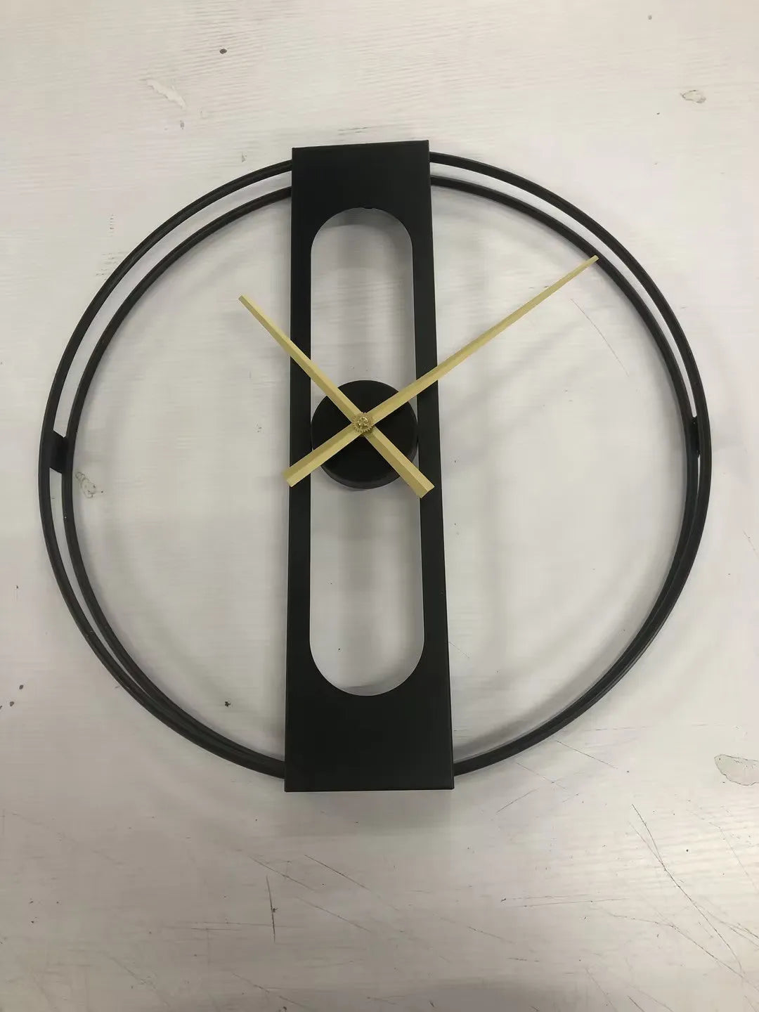 Round metal wall clock with a 50cm diameter face in a choice of black or gold colour.