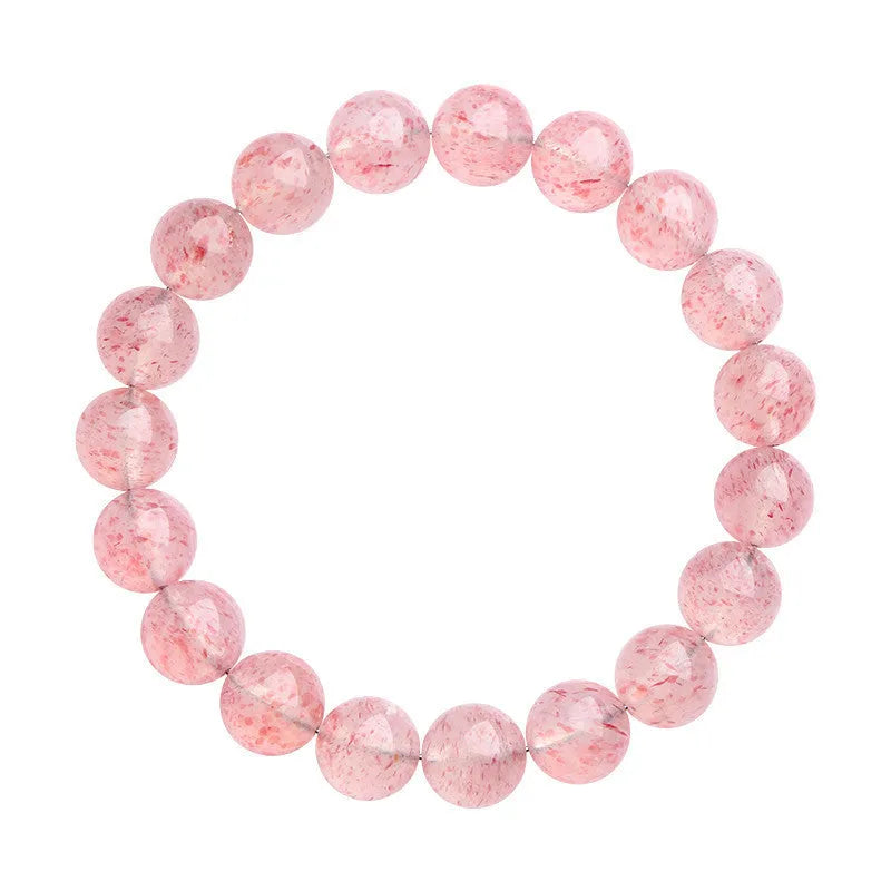 Natural white strawberry quartz crystal ball bracelet with 10mm spherical beads on wrist.