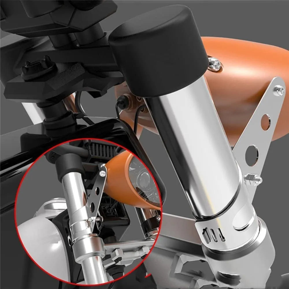 A pair of black iron motorcycle headlamp support brackets for retro bike modification.
