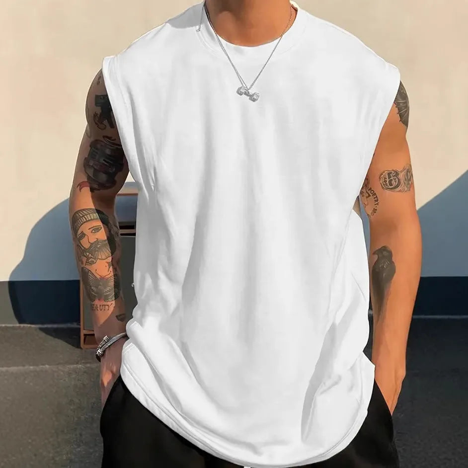 Men's solid colour loose sleeveless cotton tank top on a hanger, shown in apricot colour.