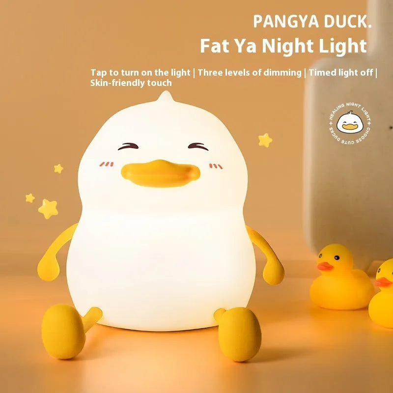 Chubby Night Light silicone desk lamp and mobile phone holder on a wooden surface.