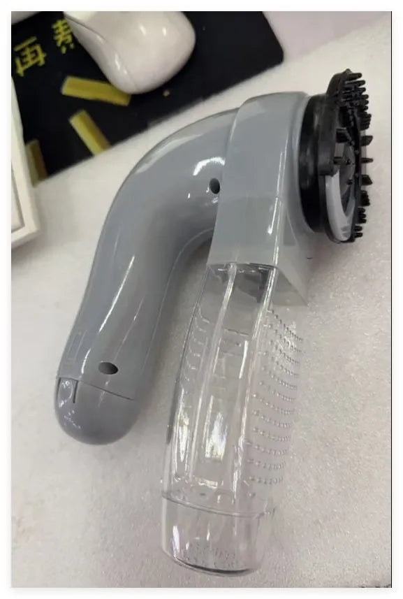 Gray handheld electric pet hair vacuum cleaner with rubber grooming head.
