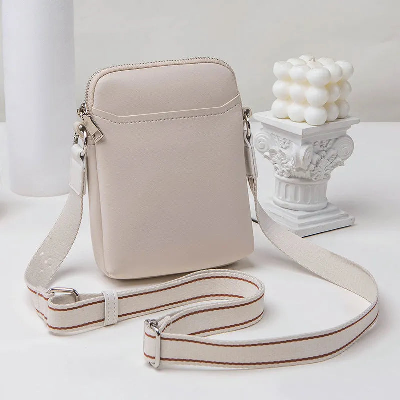 Simple solid colour PU leather crossbody phone bag for women shown in beige.