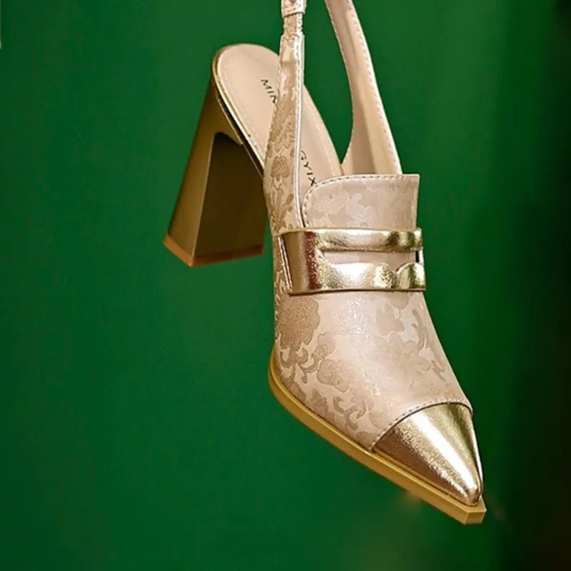 Women's black strapped sandals with a chunky block heel and pointed toe design on a white background.