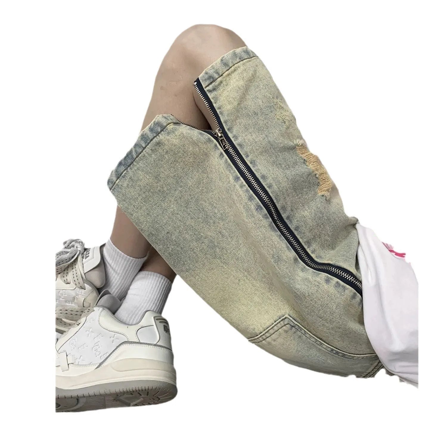 Men's blue loose-fit vintage denim shorts with yellow mud wash and ripped knee details.
