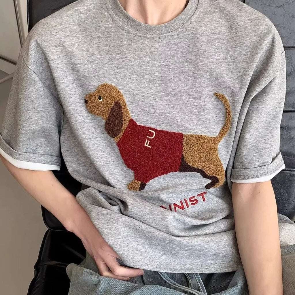 Men's grey cotton t-shirt with embroidered sausage dog and towel design showing round neck and short sleeves
