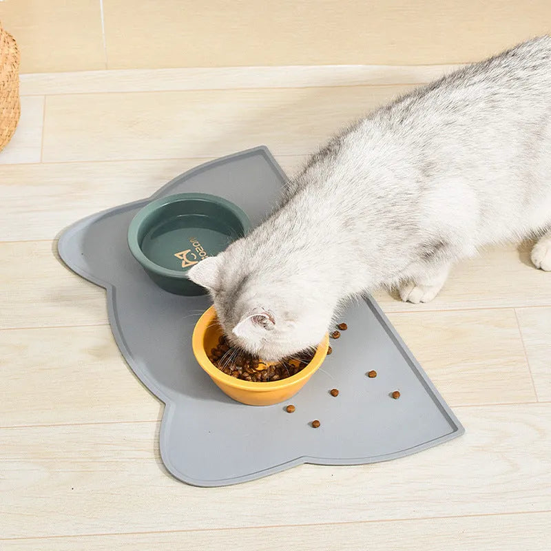 Silicone waterproof pet feeding mat with cat head design measuring 44x24cm in solid colours