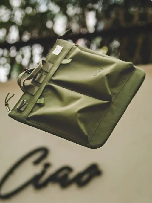 Marden Tooling Helmet canvas messenger crossbody bag in military green, showing vertical square shape and shoulder strap.