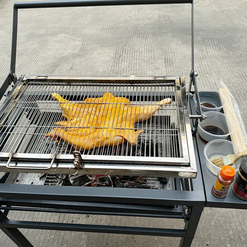 Large foldable Flip BBQ Stove charcoal grill with detachable metal frame set up in a garden.