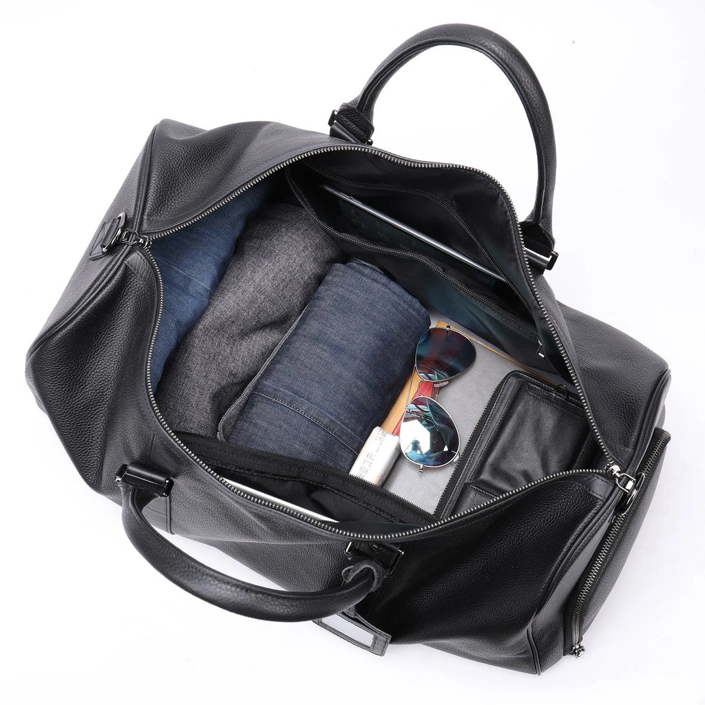Men's black leather excursion tote bag with a single shoulder strap shown next to a coffee-coloured larger version.