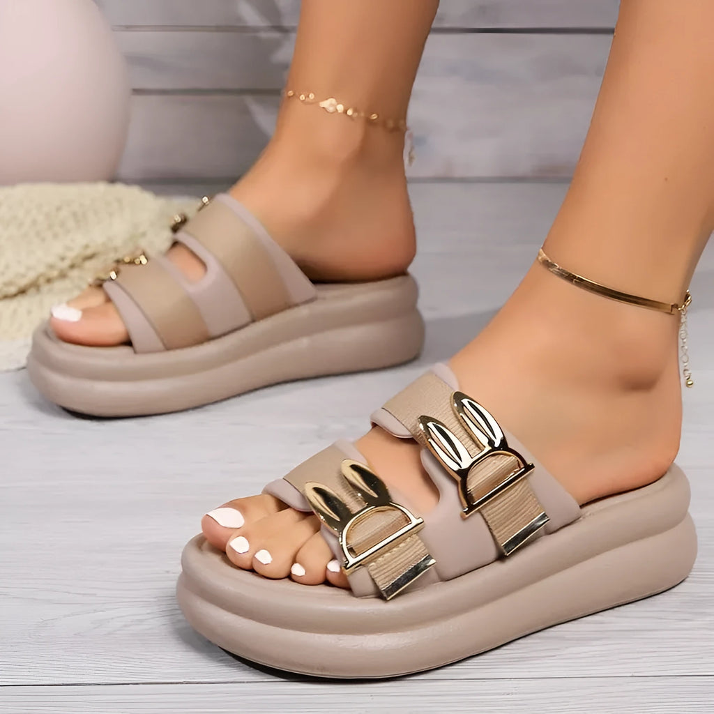 Women's apricot suede slippers with a thick rubber sole, shown from the side.