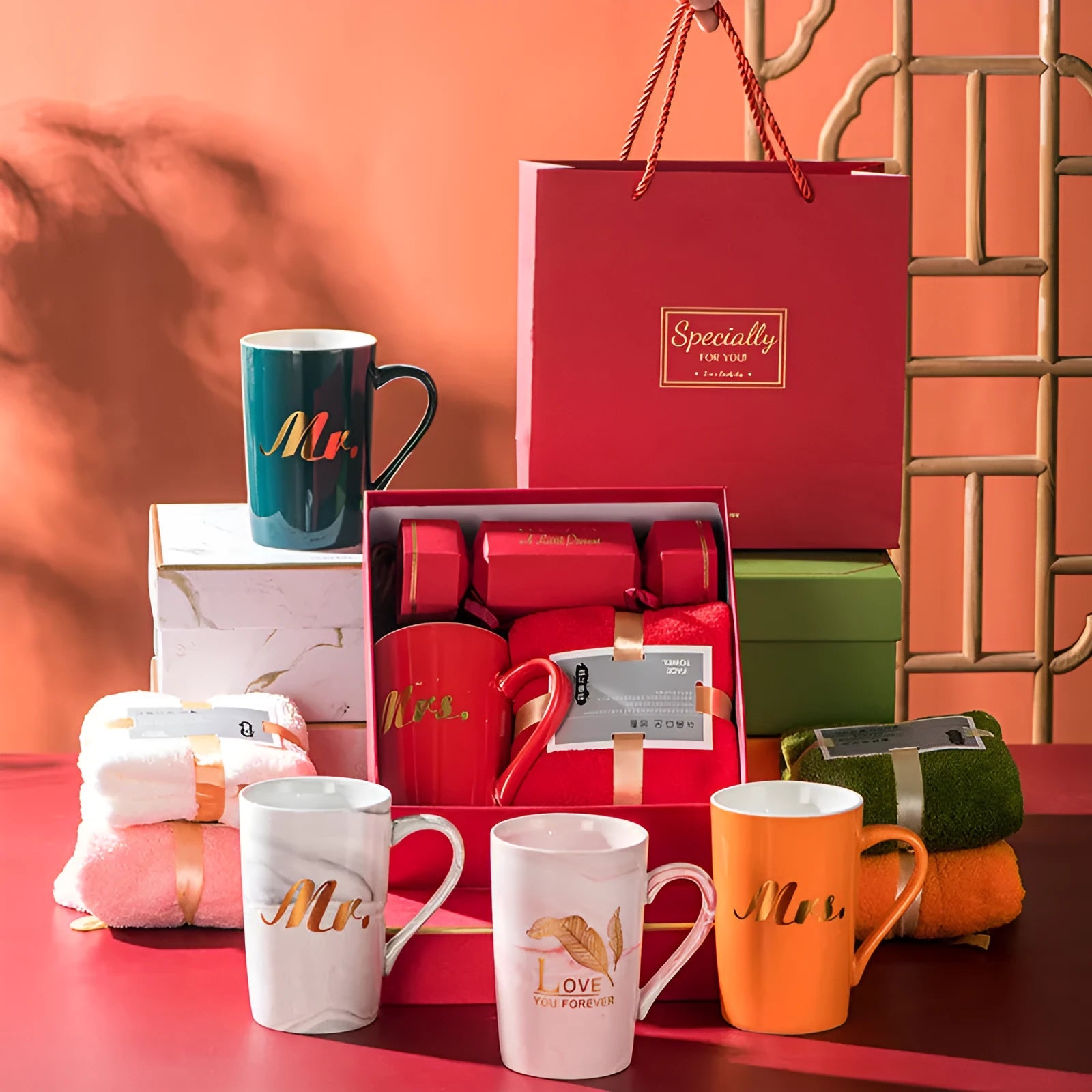 Light luxury ceramic cup gift box set with pink mug, candy, and towel on display