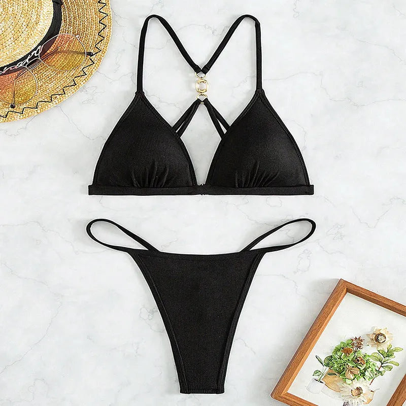 Black women's hollow backless nylon bikini set with triangle top and briefs.