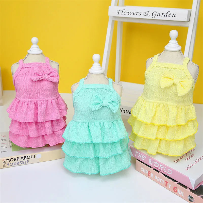 Small dog wearing polyester princess dress with layered skirt in candy colours