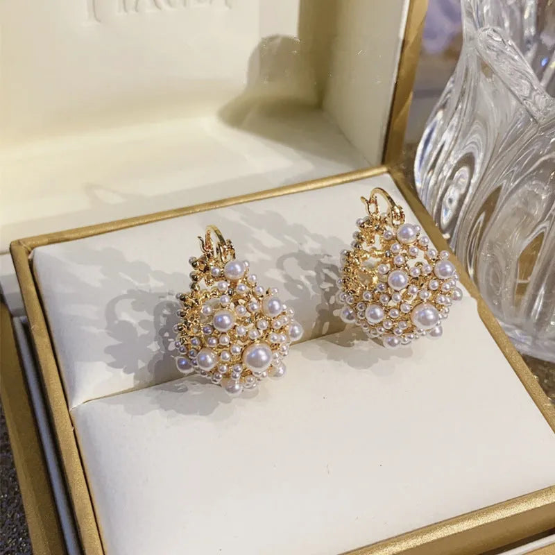 Gold-colour women's flower basket earrings with copper construction and small bead inlay detail.