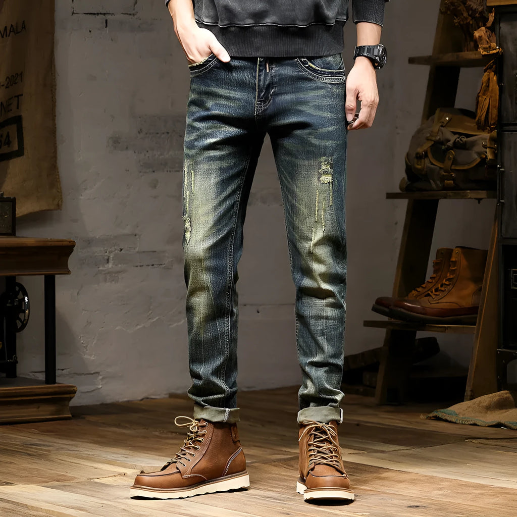 Men's skinny fit jeans in a retro colour with a zip fly, shown laid flat.