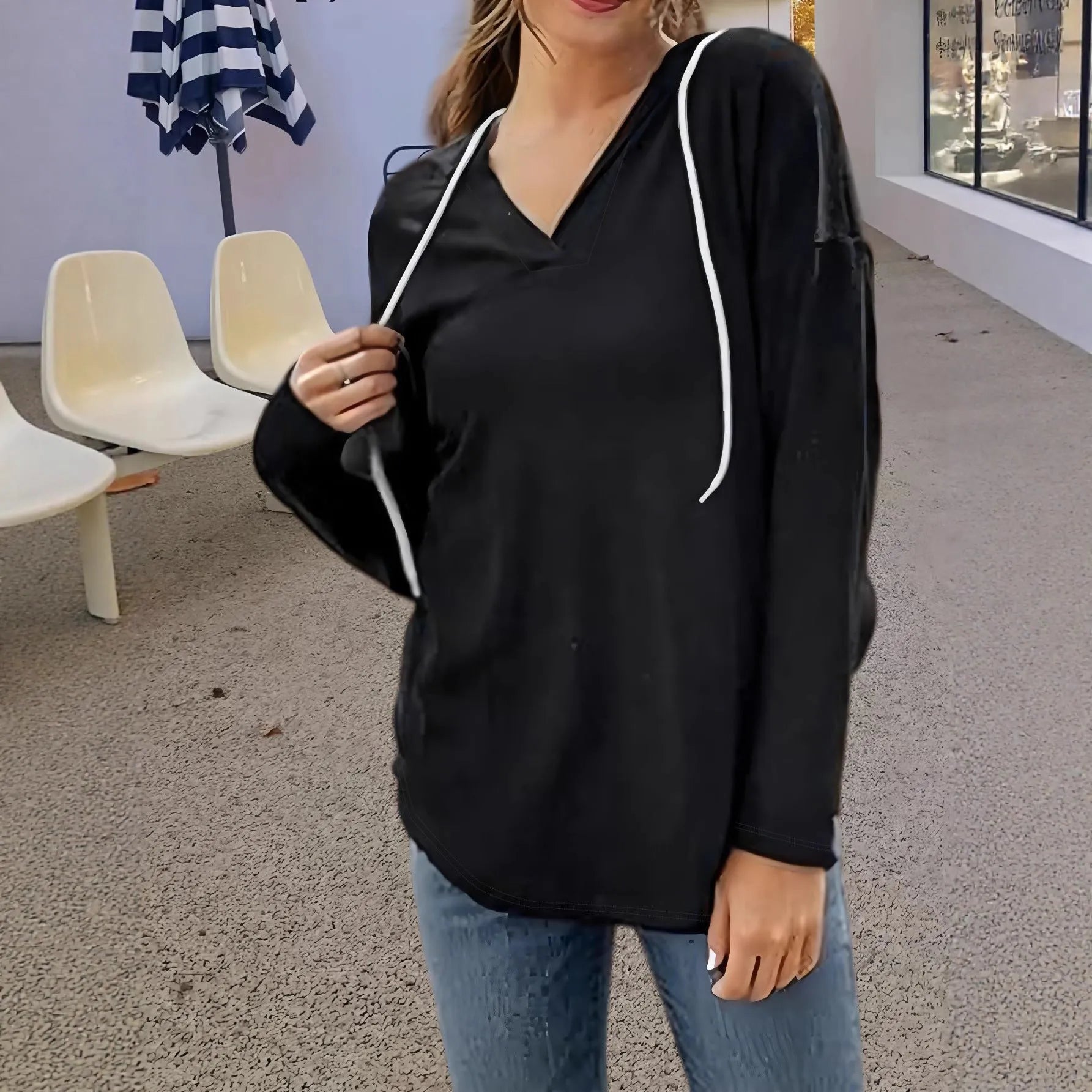 Red women's V-neck sweatshirt with a hood and long sleeves laid flat.