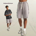 Men's batik washed patch cotton terry shorts in a loose retro street style, shown in batik black.