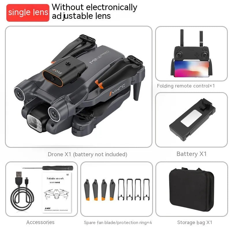 Black quadcopter drone with camera folded on a surface next to its remote control.
