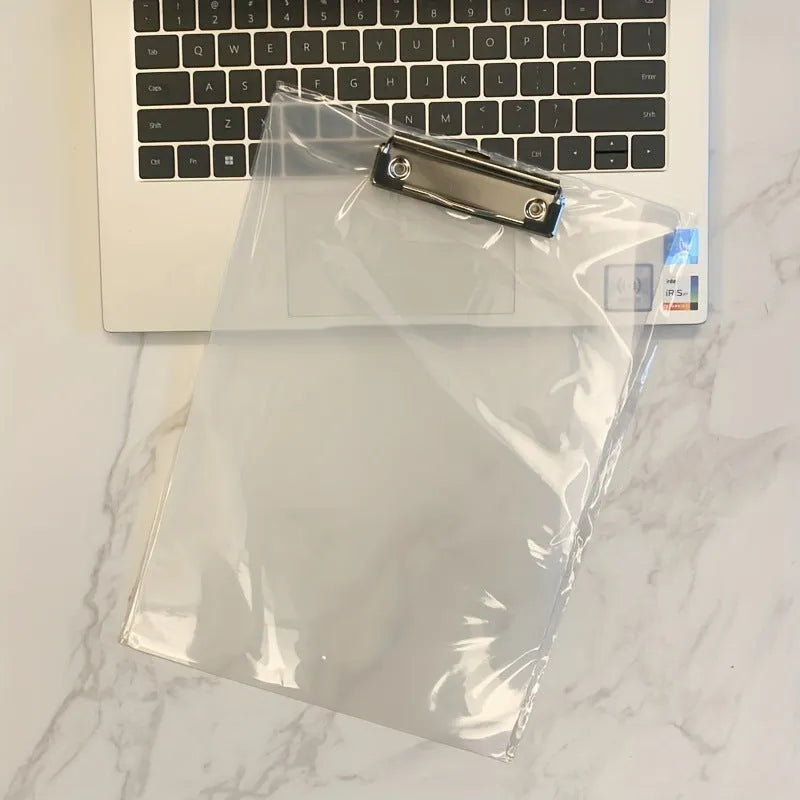 Transparent A4 plate holder with metal clip in blue, holding white paper, on a wooden desk.