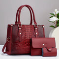 Burgundy PU leather crossbody bucket bag, wallet, and card holder three-piece set displayed together