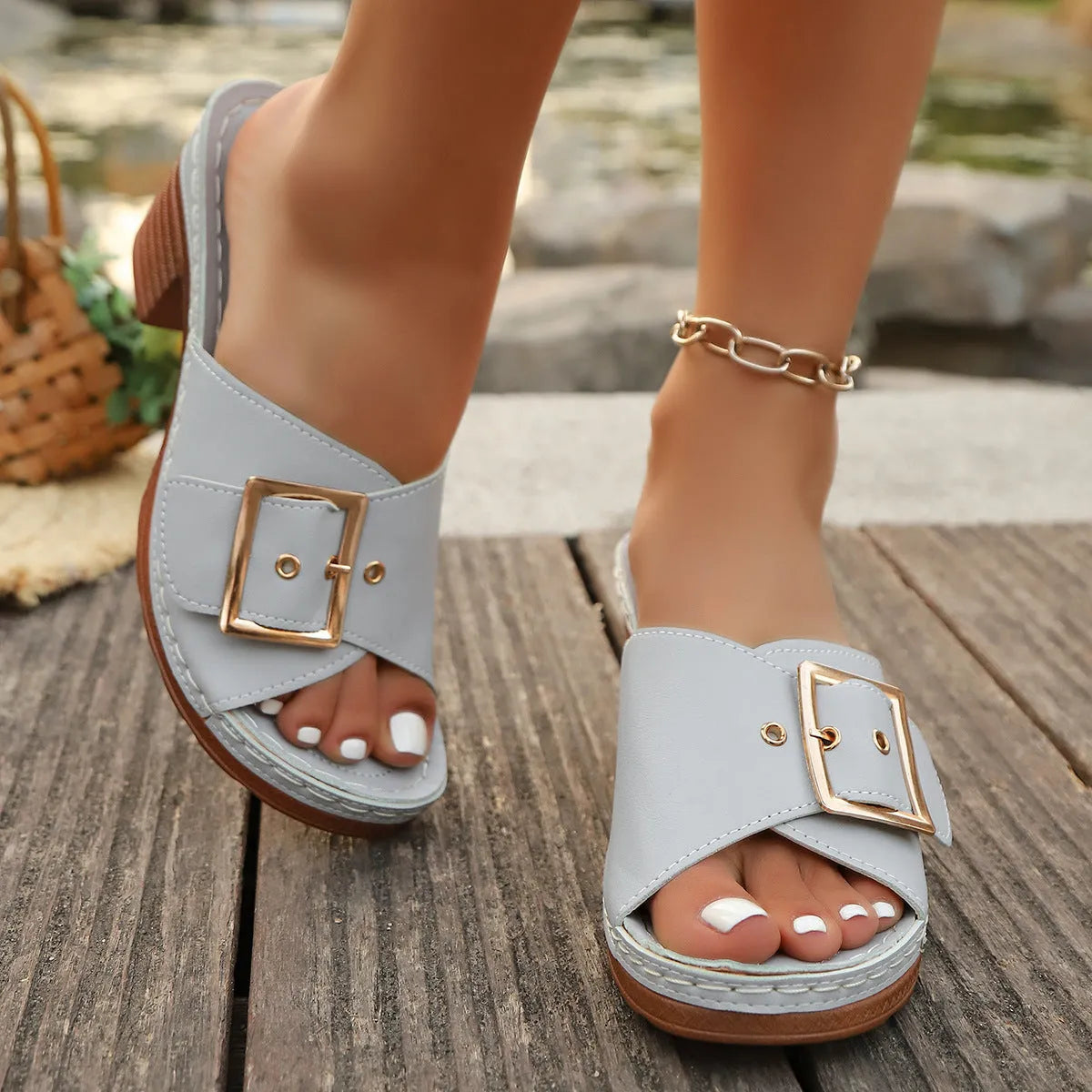 Women's black and light blue chunky heel slippers with metal buckle detail and round toe