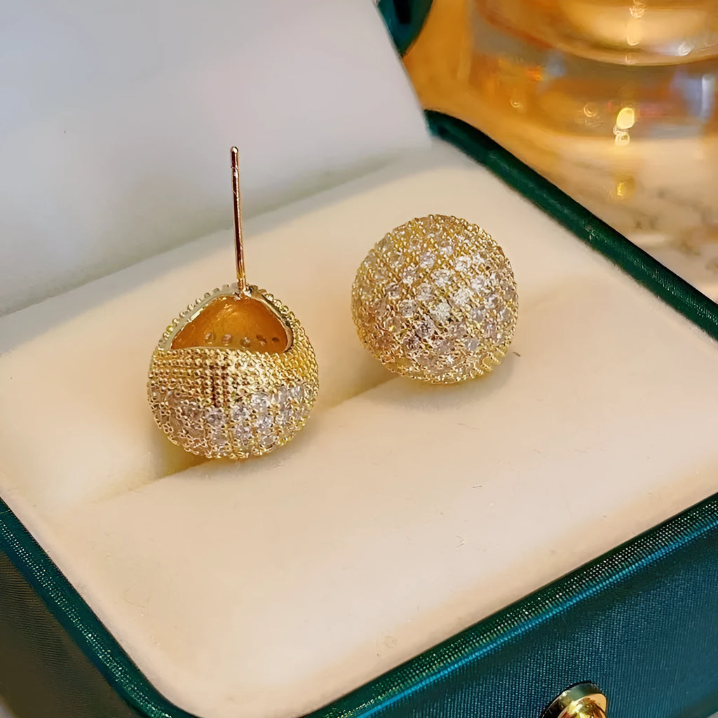 Gold or white geometric drop-shaped clip earrings with spherical bead elements