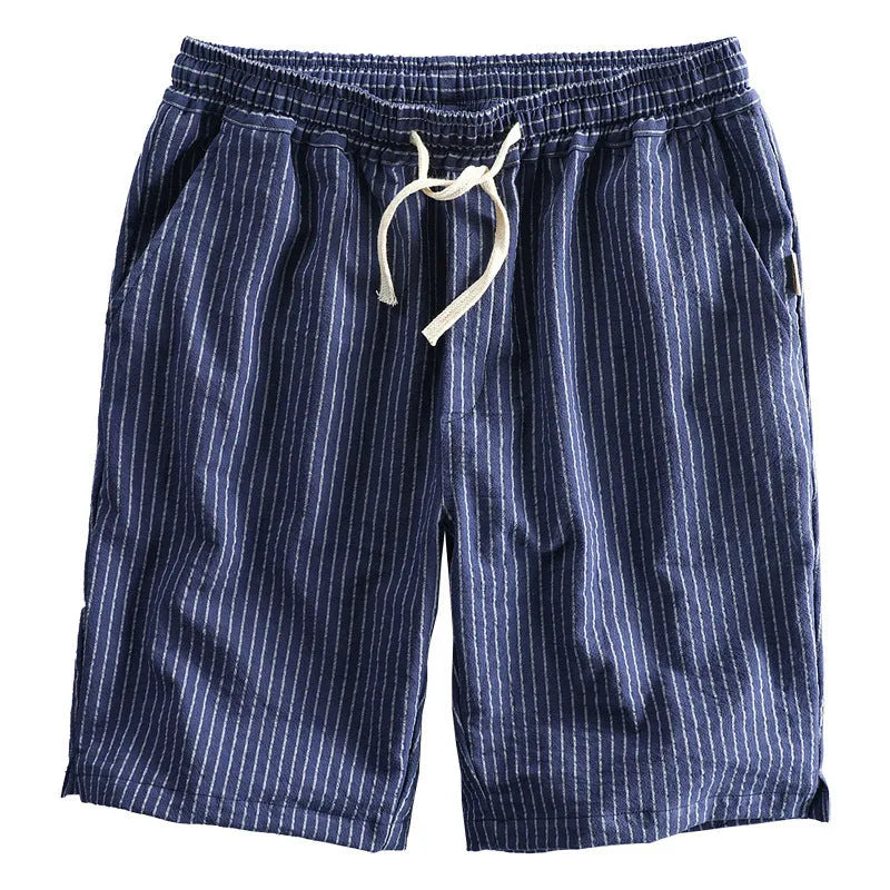 Man wearing black and white striped casual cotton shorts with a loose straight fit.